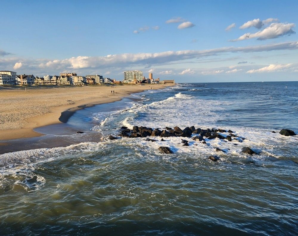 Beach with Waves, Sandy Shore, Buildings, and Blue Sky with Clouds — Ryphen Electrical in Ocean Grove, VIC