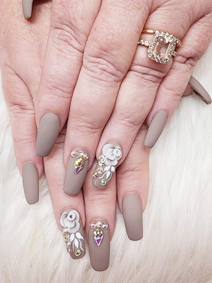 A woman's nails with a ring on her finger.