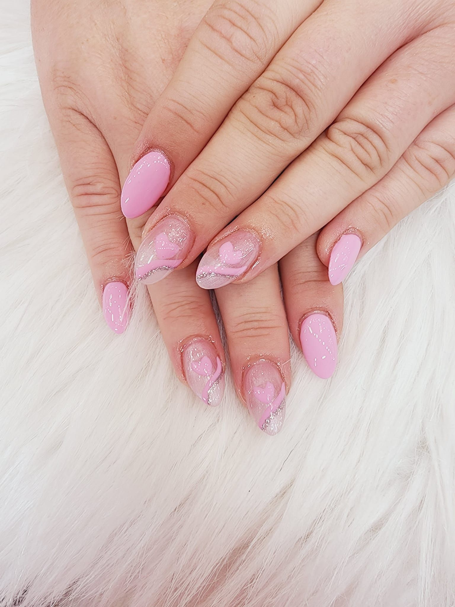 A close-up of a woman's hands with pink nails.