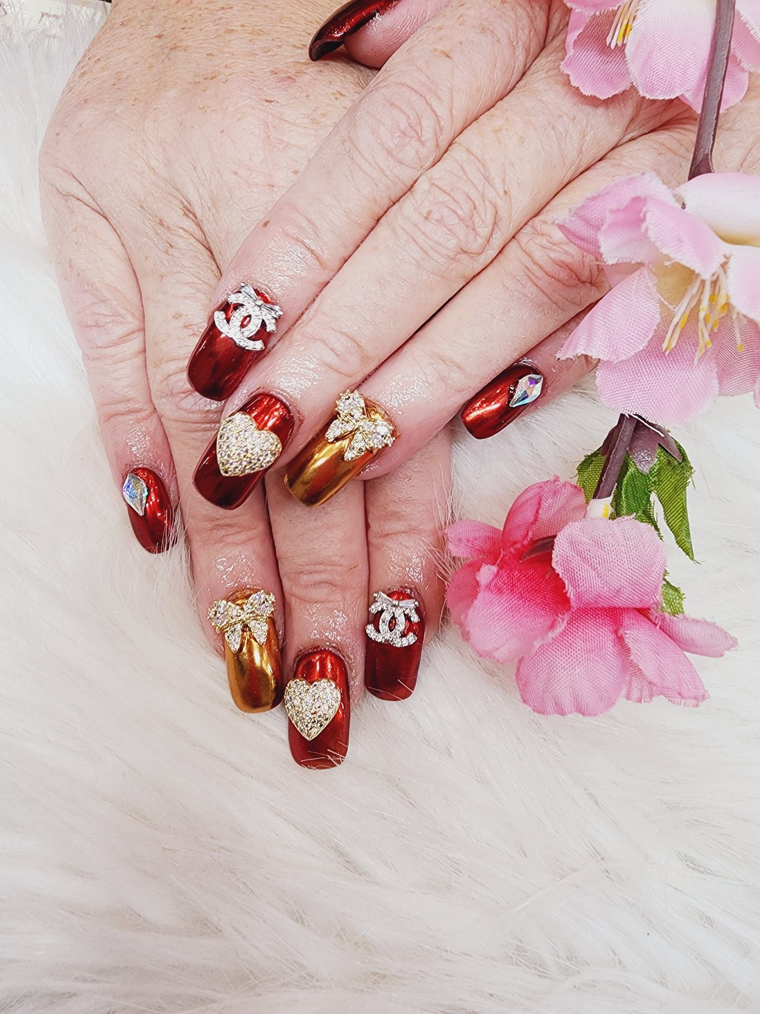 A close-up of a woman's nails with flowers.