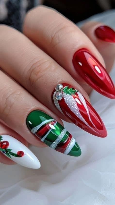 A close up of a person 's nails with a christmas design on them.