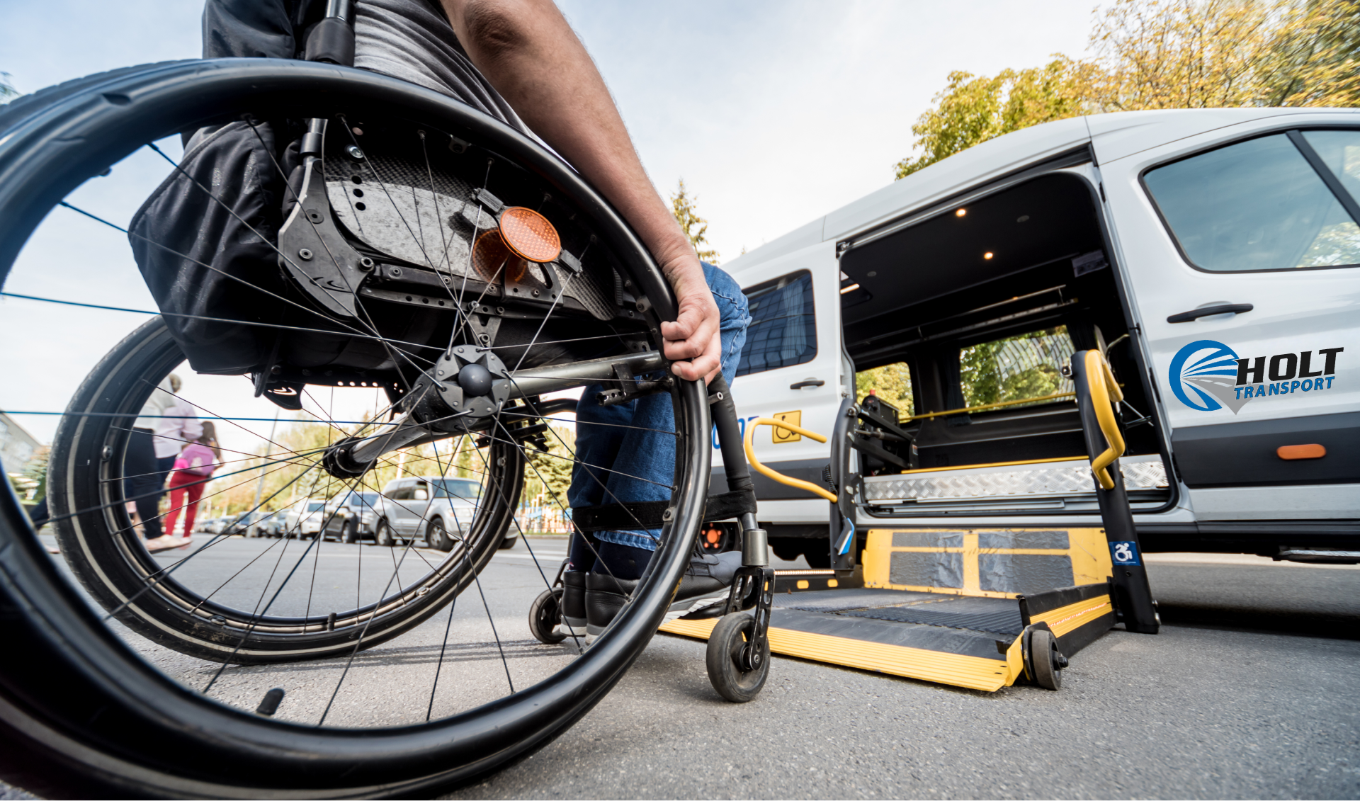 A person in a wheelchair is getting out of a van.