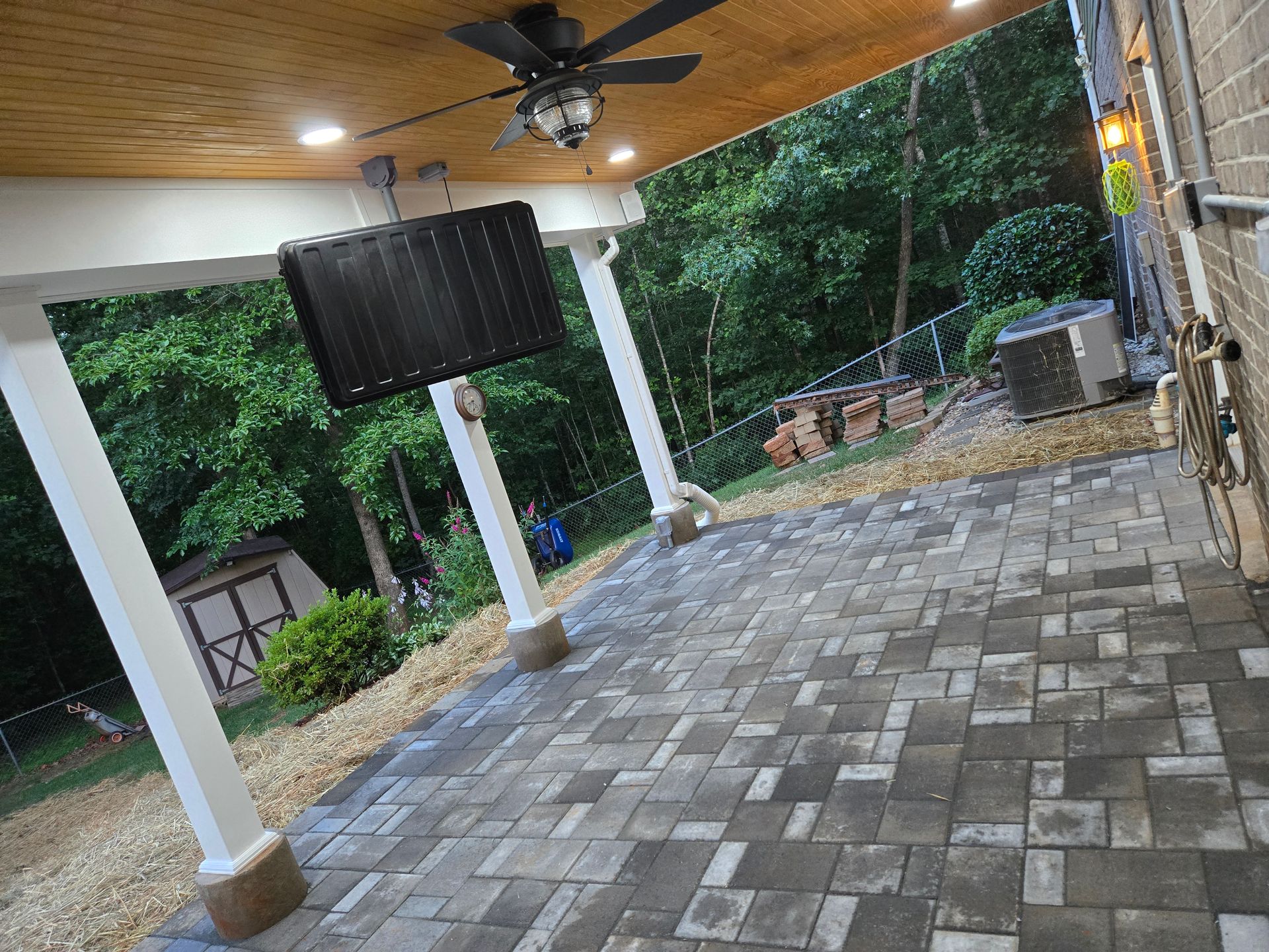 A sunny, tiled conservatory features a cushioned wicker rocking chair.