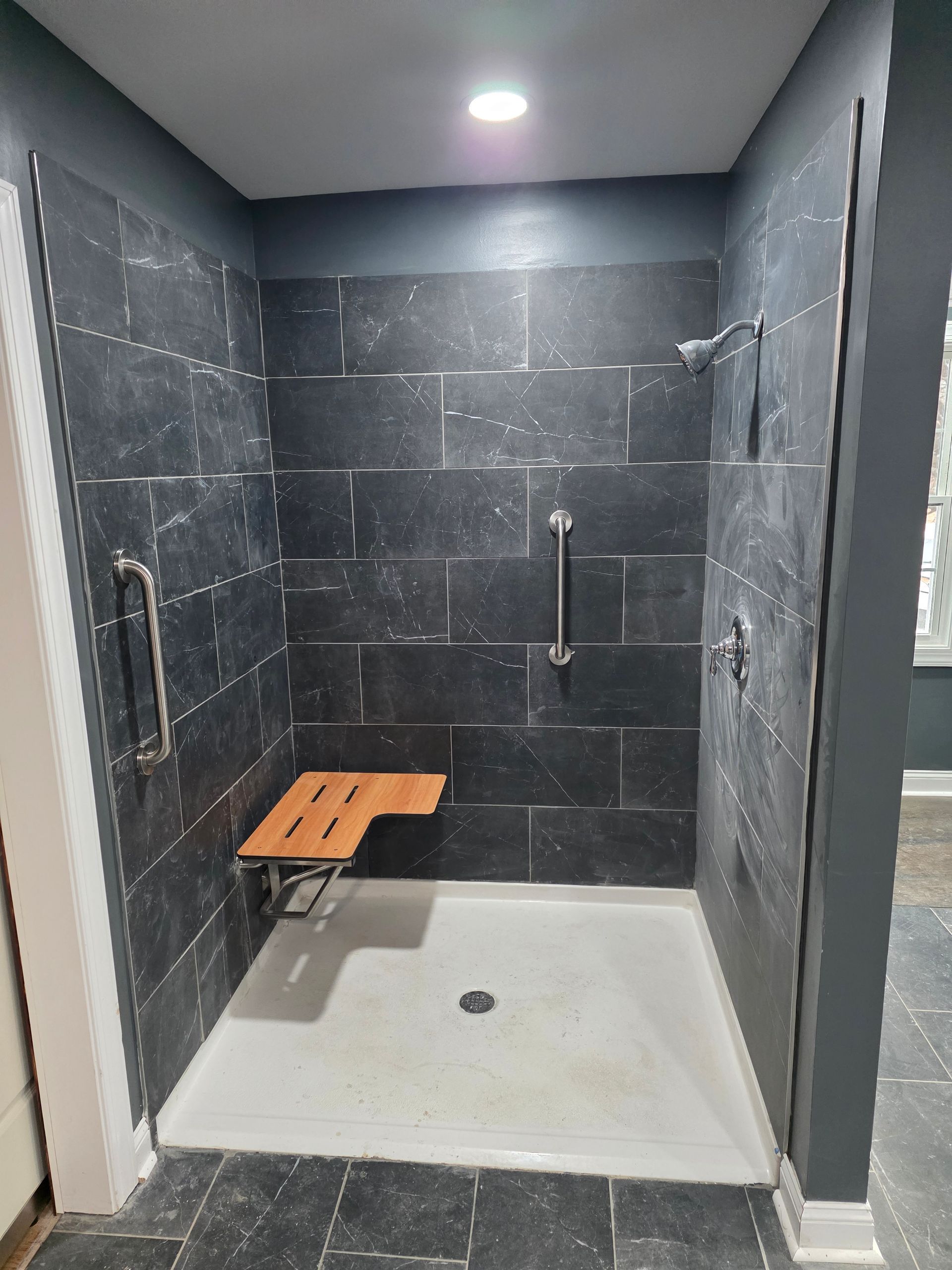 A modern, white-walled living room with hardwood floor.