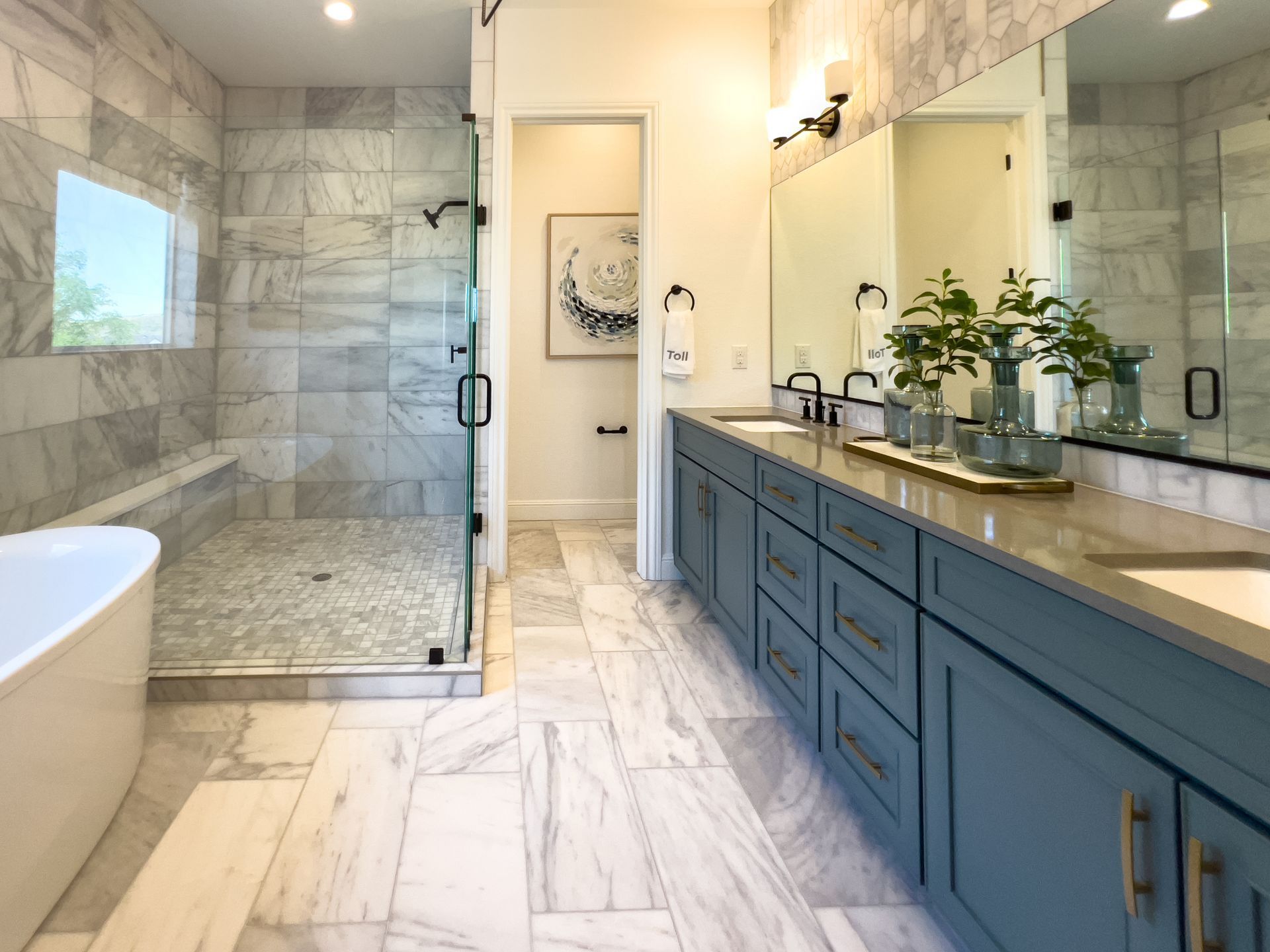 A modern bathroom with a double blue vanity.