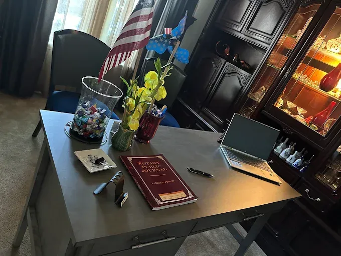 Two technicians repairing water damage: One kneels with a tool, the other adjusts a blower.