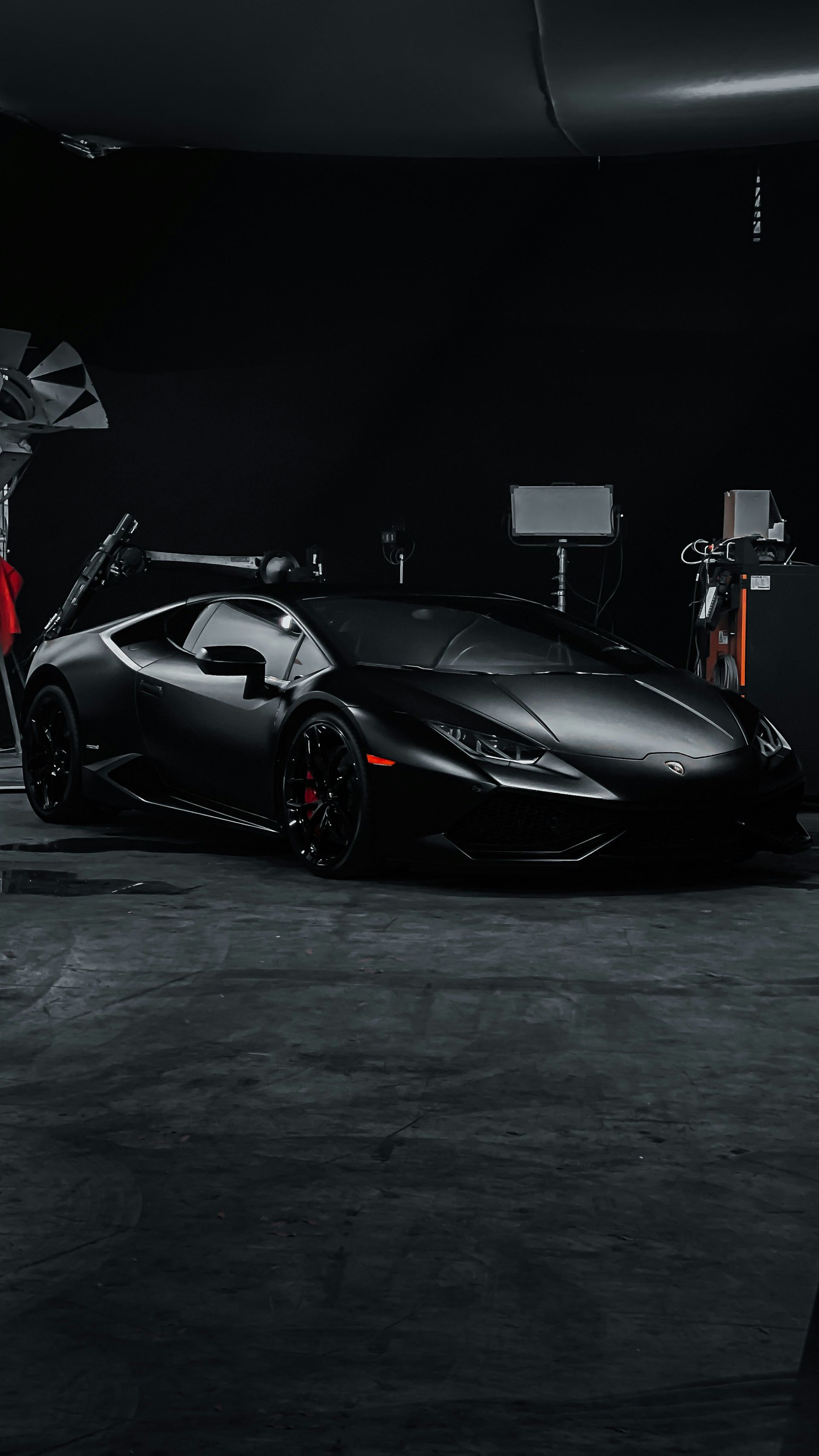 Person wearing black gloves, working on a car detail, close-up.