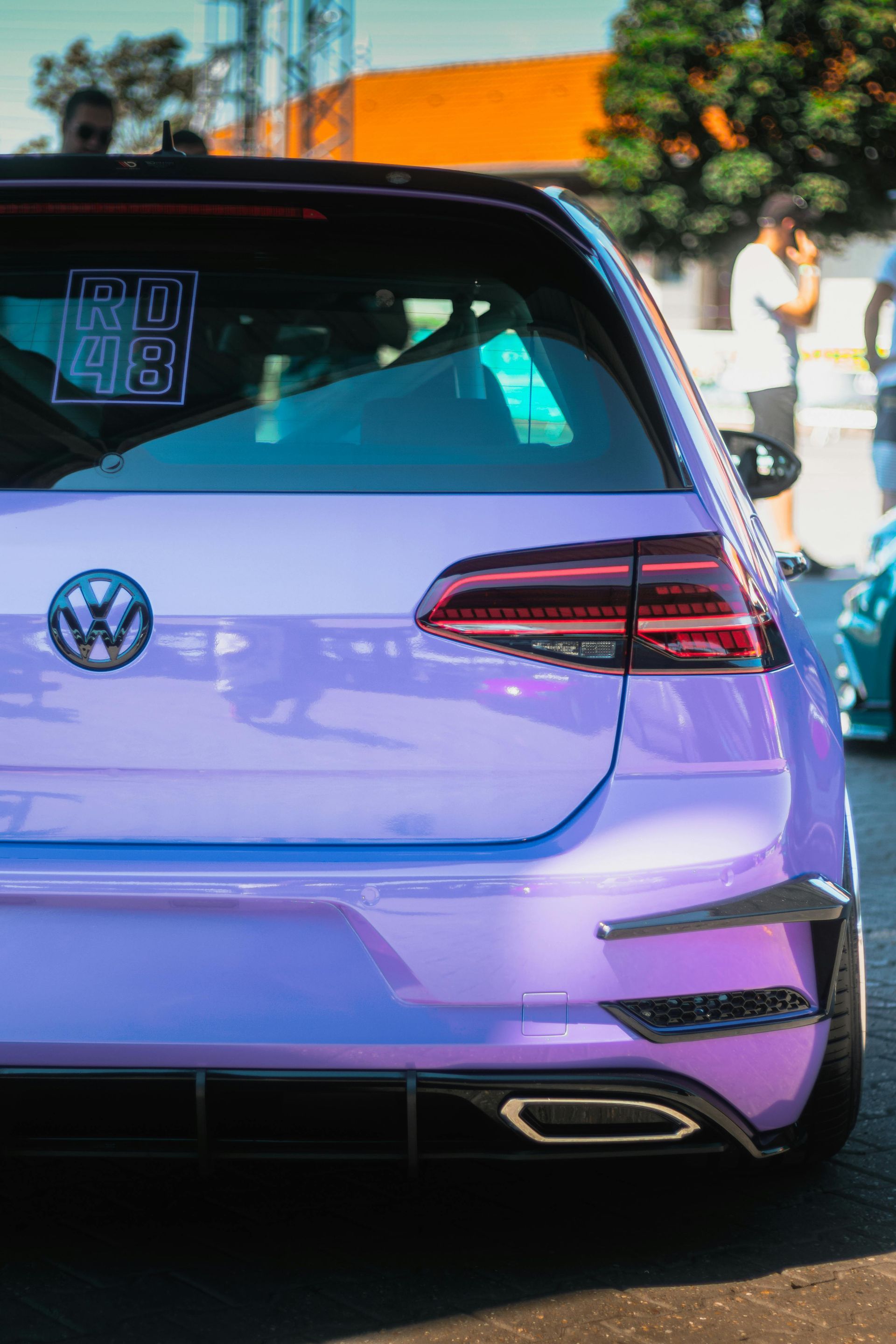 Purple Volkswagen Golf hatchback with custom bodywork, rear view.