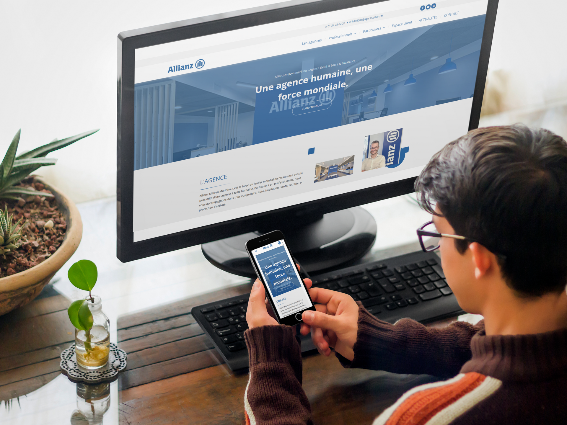Une personne utilise un smartphone et un ordinateur, comparant éventuellement le contenu de sites web sur les deux appareils.