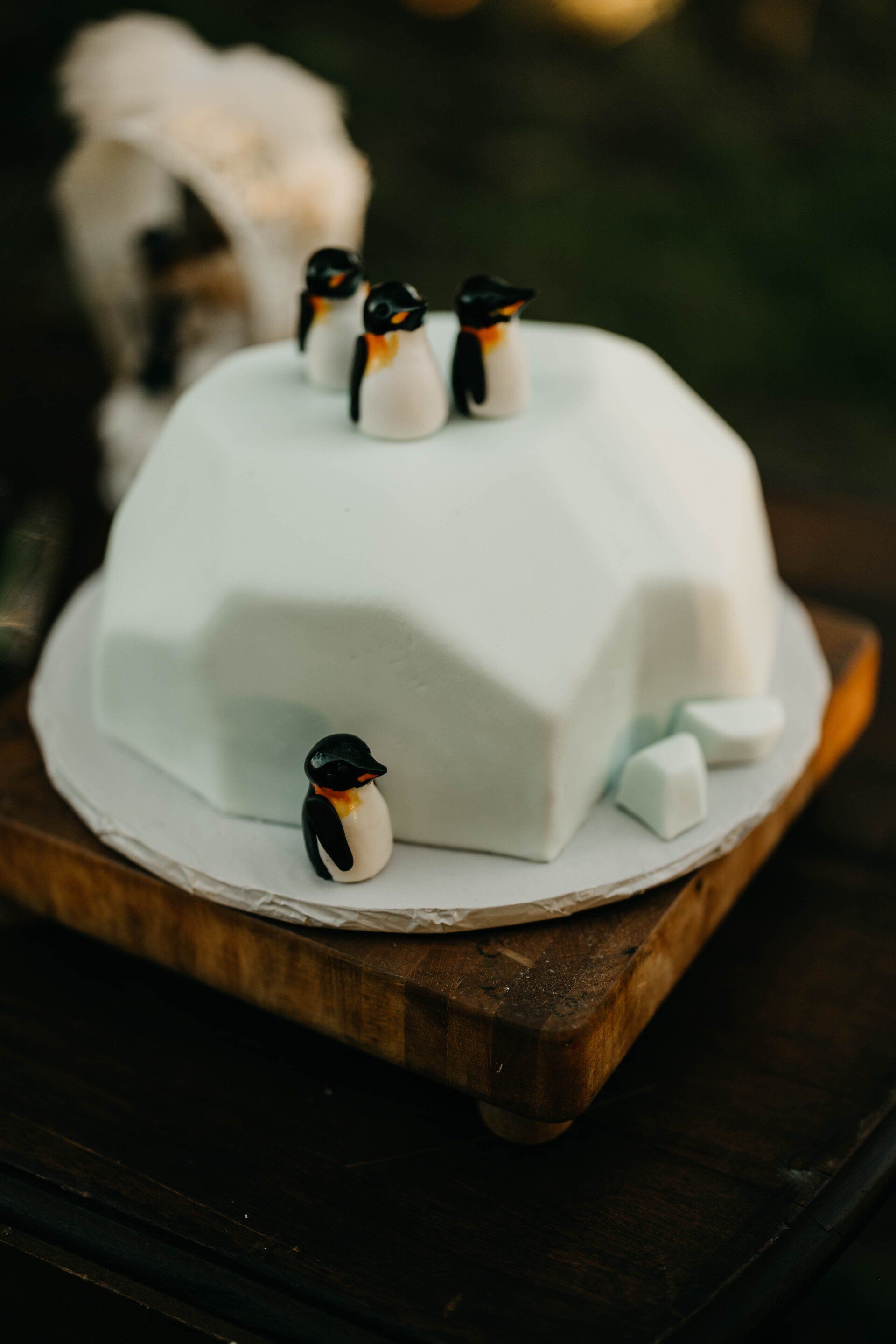 a cake that looks like an iceberg with penguins on top