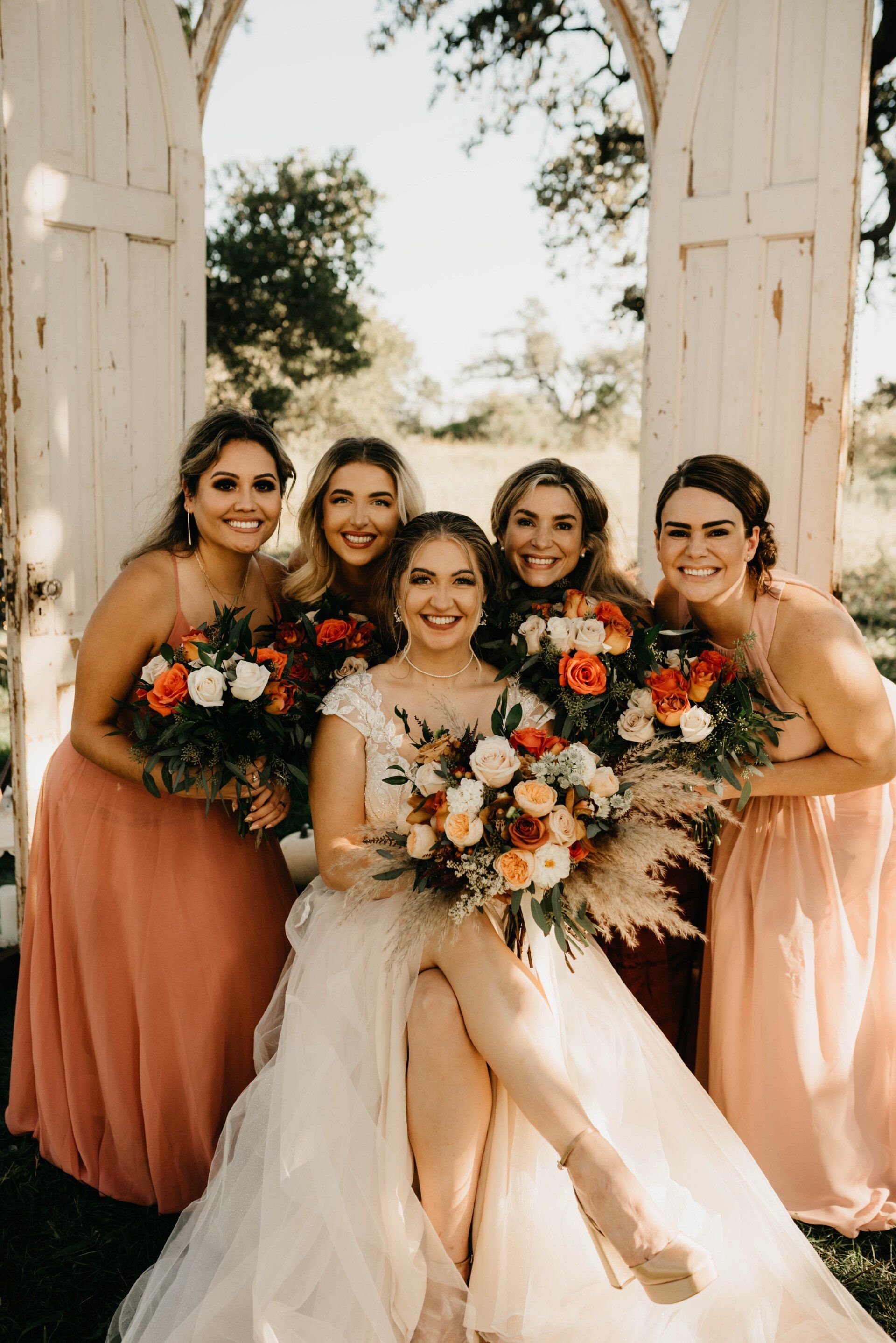 a bride and her bridesmaids pose for a picture