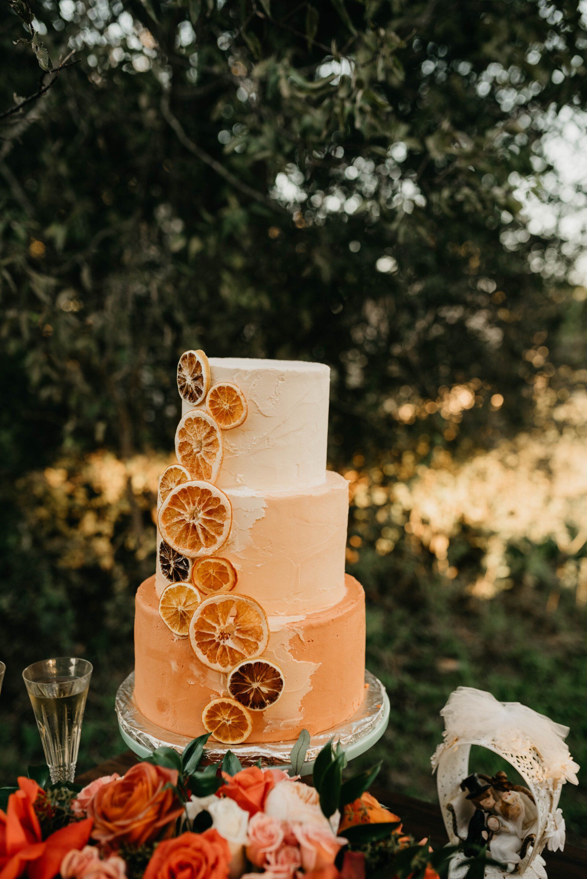 a three tiered cake with orange slices on it