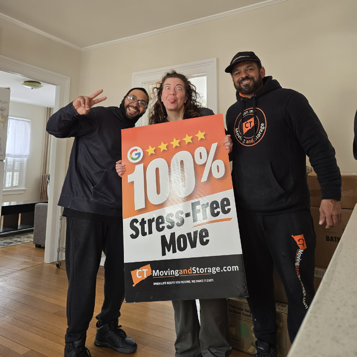 Three people holding a sign that says