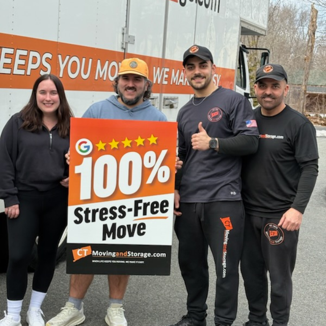 Four people with a sign that says 