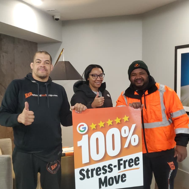 Three people holding sign: 