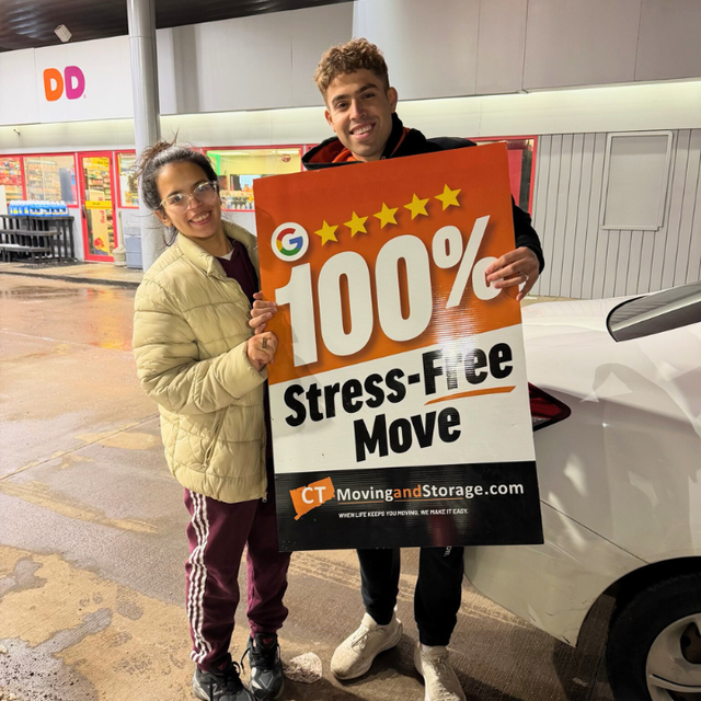 Two people holding sign that says 