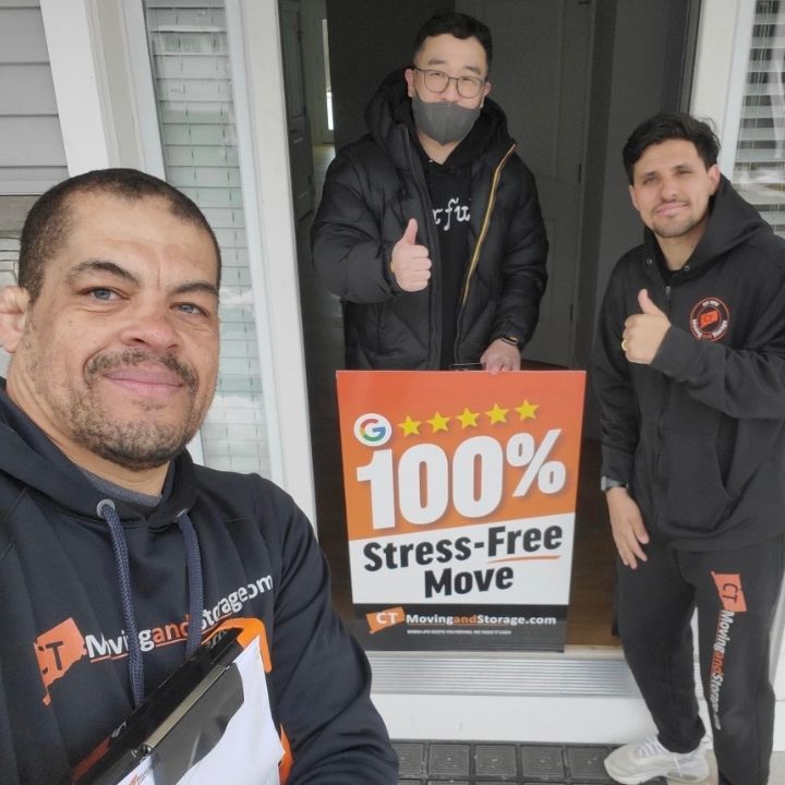 Three movers posing on a porch with a 