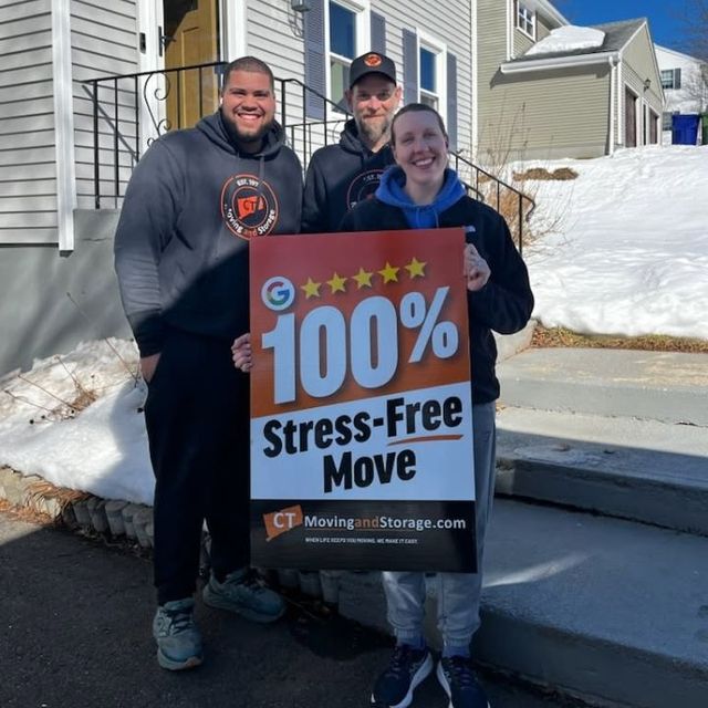 Three people with a sign that says 