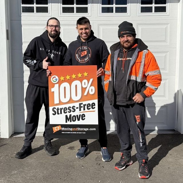 Three men holding a sign that says 