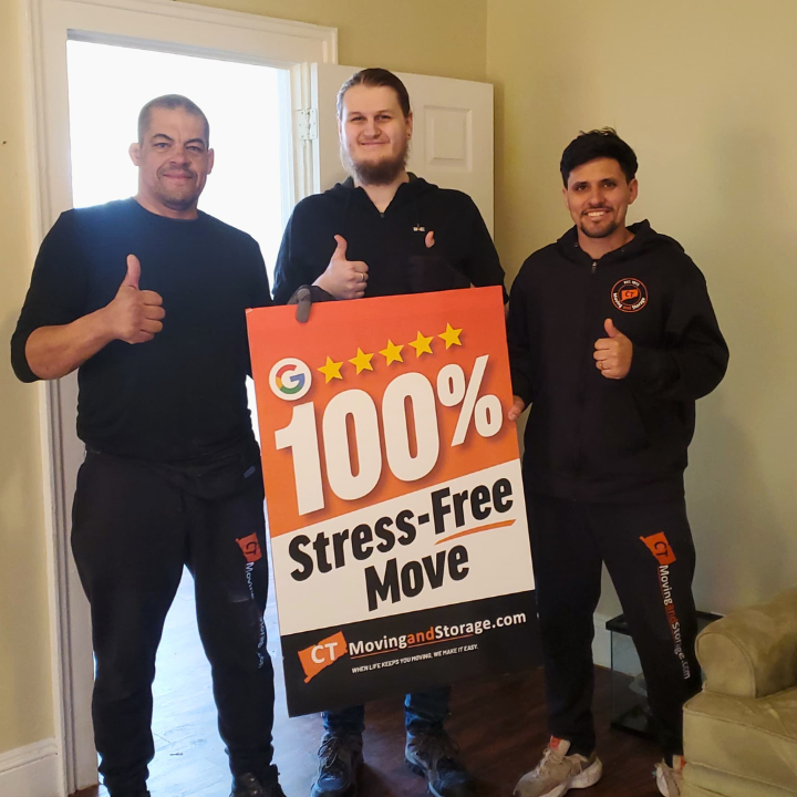 Three men holding a sign that says