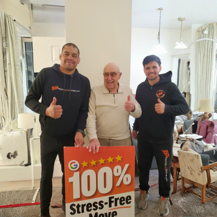 Three people smiling, giving thumbs-up. One holds a sign: