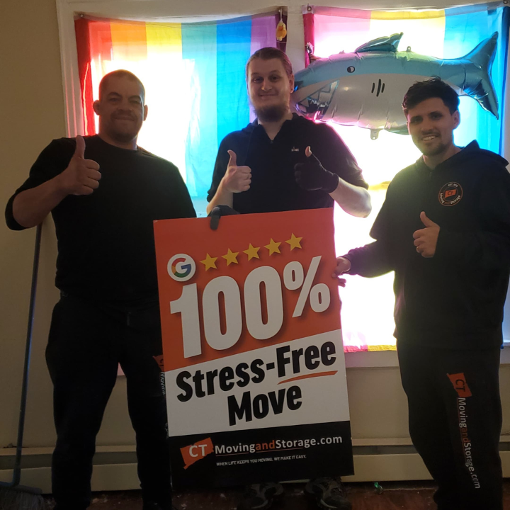 Three men holding a sign that says