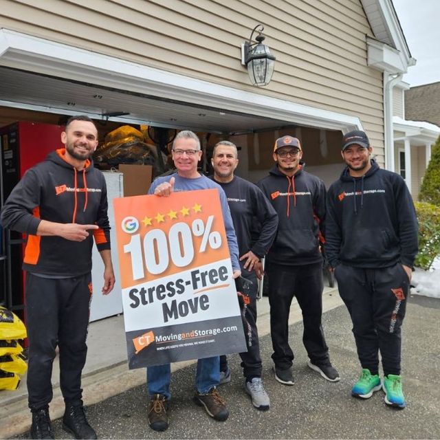 Moving crew with customer holding sign: 