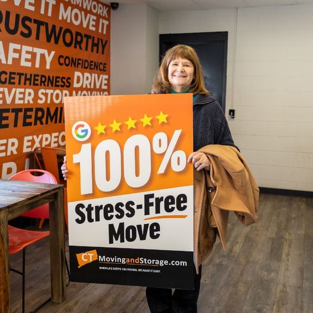 Woman holding a sign for 