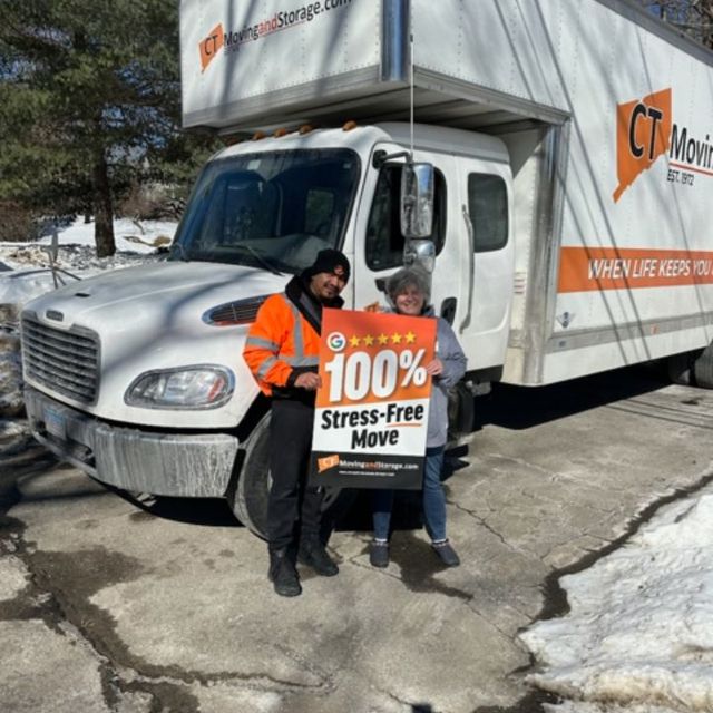 Man in orange vest and woman holding 