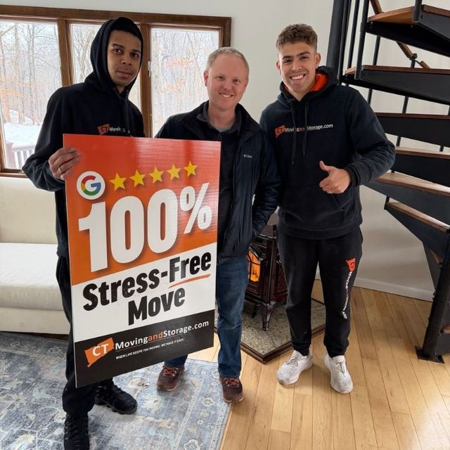 Three people holding a sign that says 