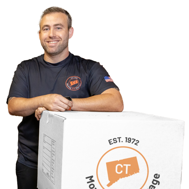 A mover holding a CT Moving & Storage box.