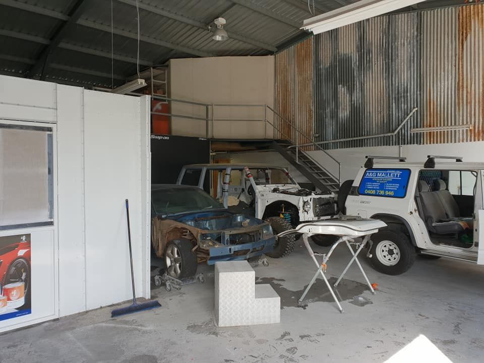 A Jeep Is Being Worked On In A Garage — East Coast Panel & Paint In Woolgoolga, NSW