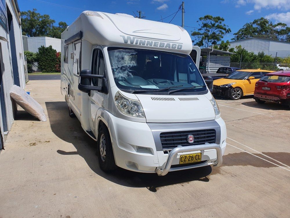 A White Camper Van Is Parked In A Parking Lot — East Coast Panel & Paint In Woolgoolga, NSW