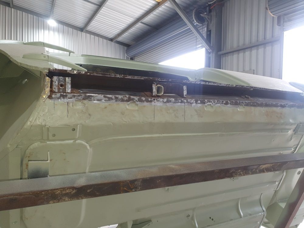 A Large Piece Of Metal Is Sitting In A Warehouse — East Coast Panel & Paint In Woolgoolga, NSW