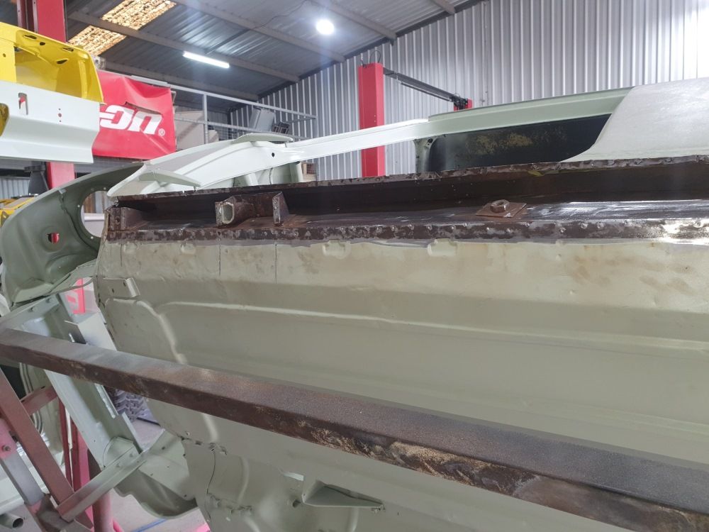 A Car Is Being Worked On In A Garage — East Coast Panel & Paint In Woolgoolga, NSW