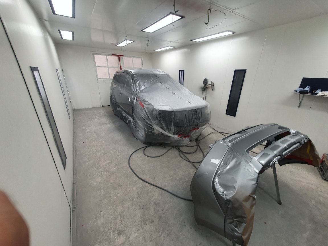 A Car Is Being Painted In A Garage — East Coast Panel & Paint In Woolgoolga, NSW