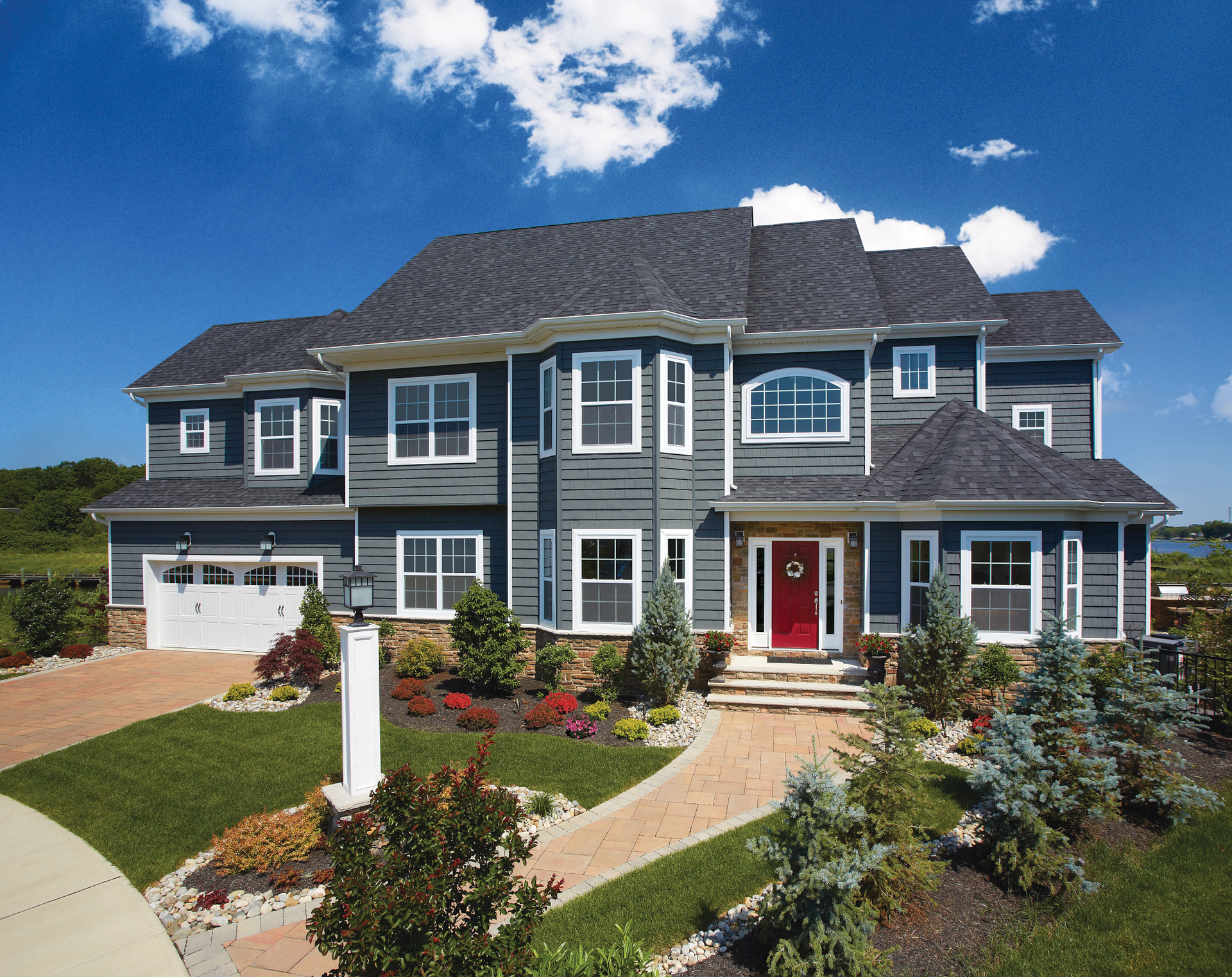 A large house with a lot of windows and a red door
