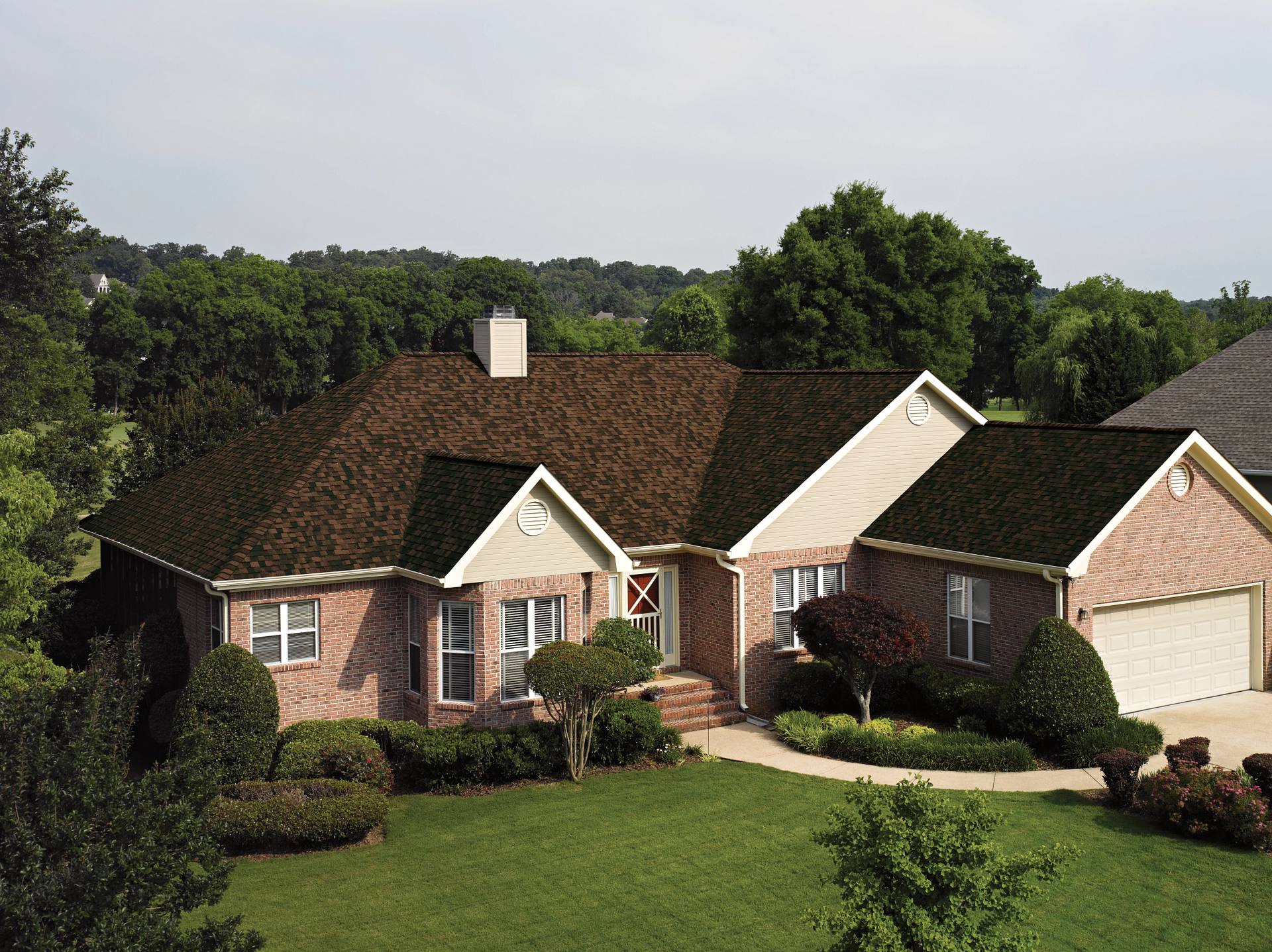A large brick house with a brown roof
