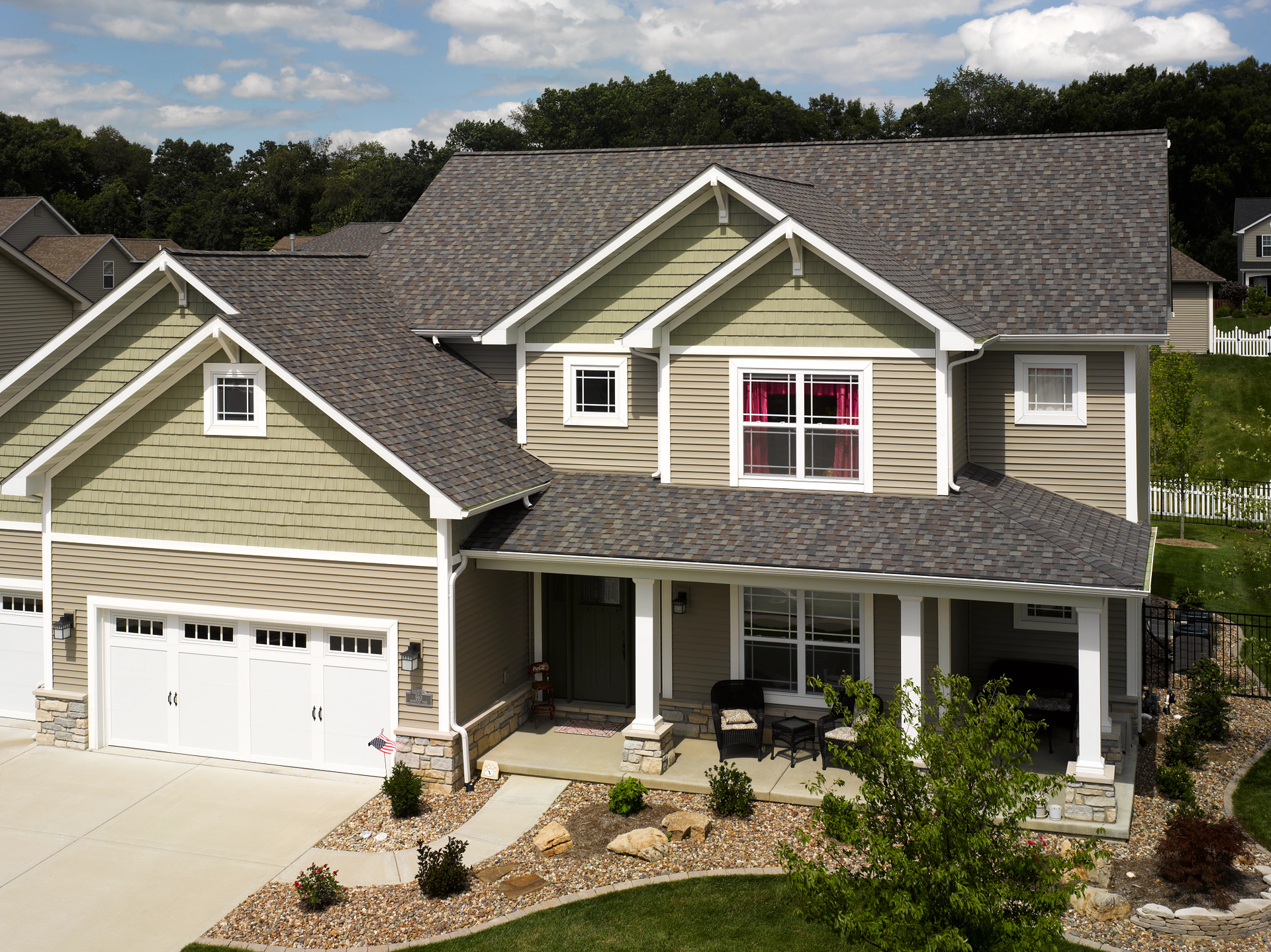 An aerial view of a large house with a gray roof