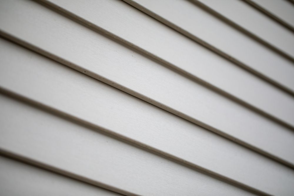 A close-up of grey vinyl siding on a house.