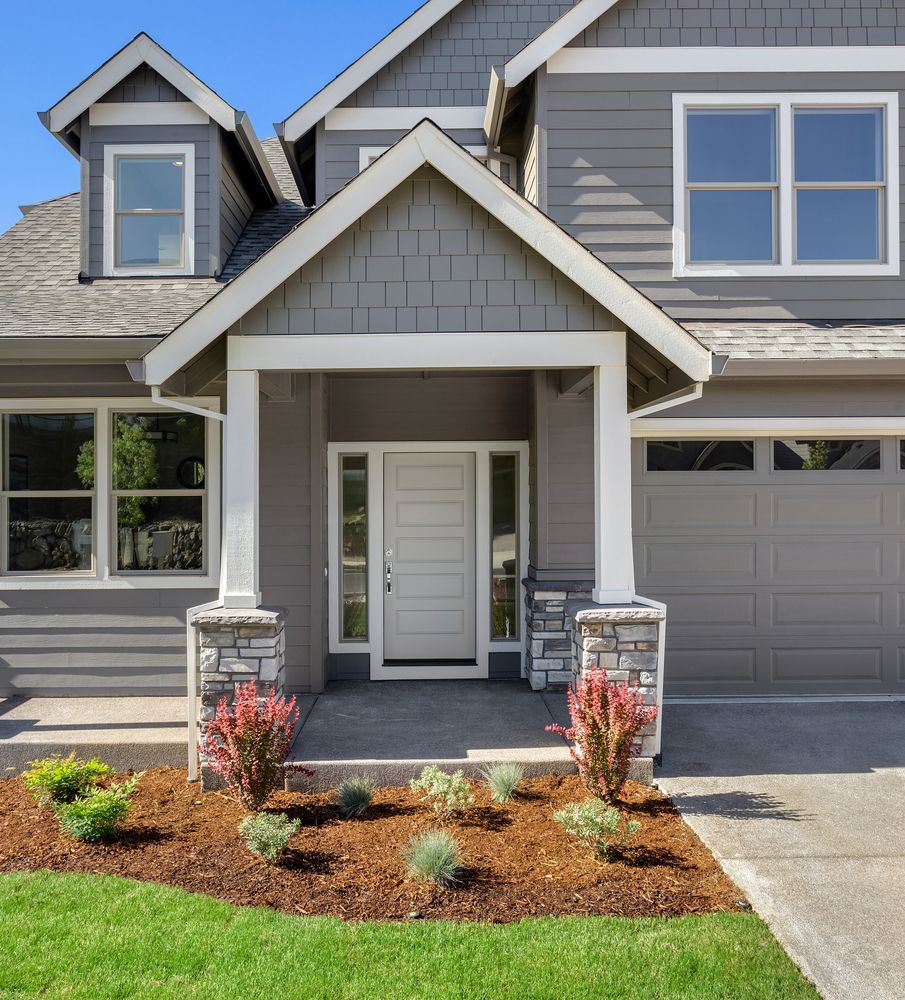 House with gray siding and a nice entryway.