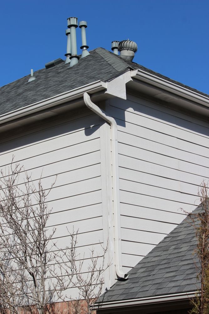 A house with a gutter and chimneys on the roof