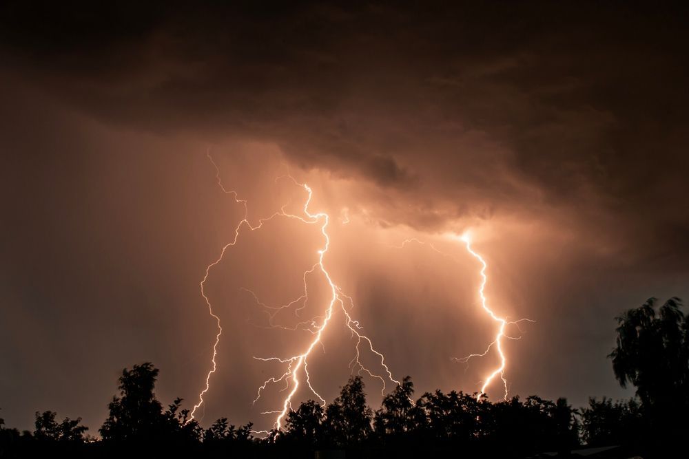 There is a lot of lightning in the sky at night.