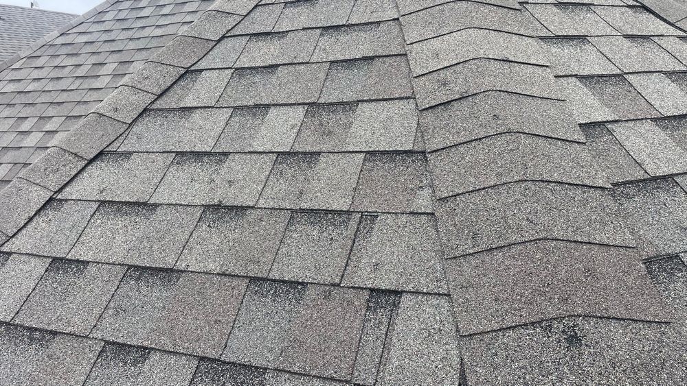 A close up of a roof with a lot of shingles on it.