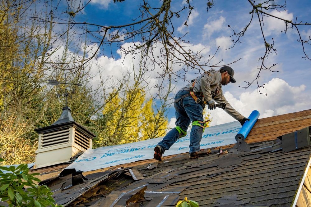 A man is working on the roof of a house.
