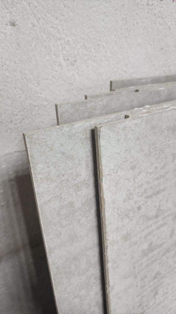 A stack of concrete tiles sitting on top of each other on a table.