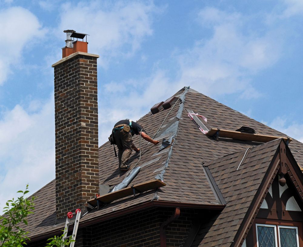 A man is working on the roof of a house