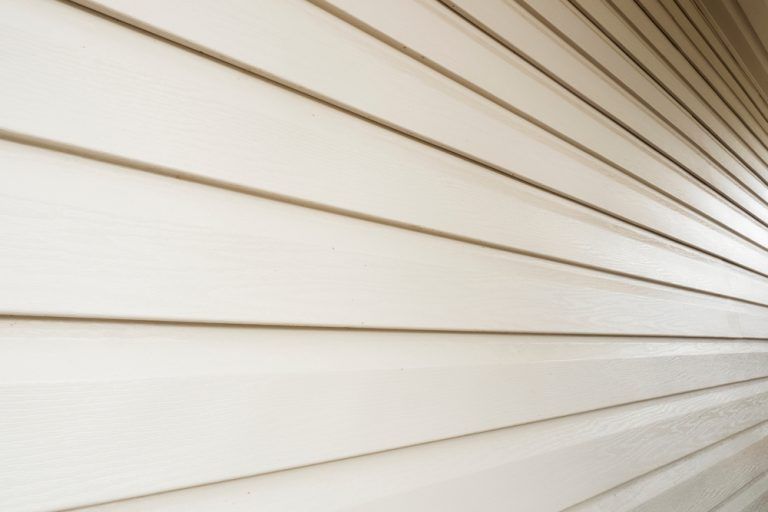 A close up of a white siding on a house.