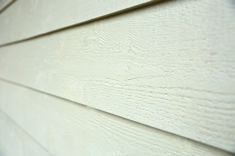 A close up of a white siding on a house.