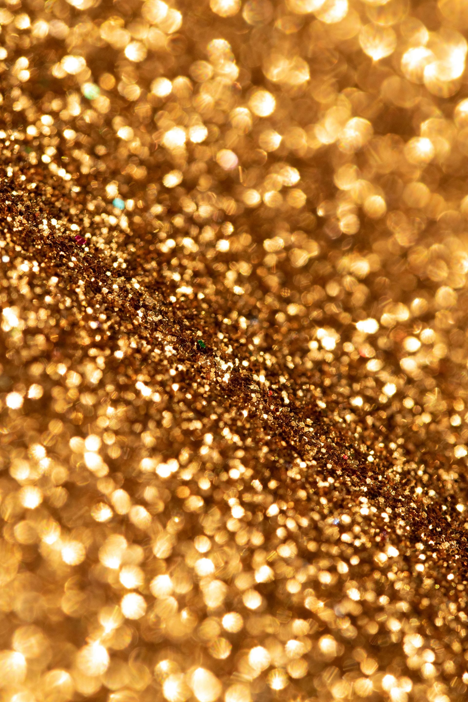 Email Us About Sponsoring This Event Golden glitter texture with sparkling light reflections